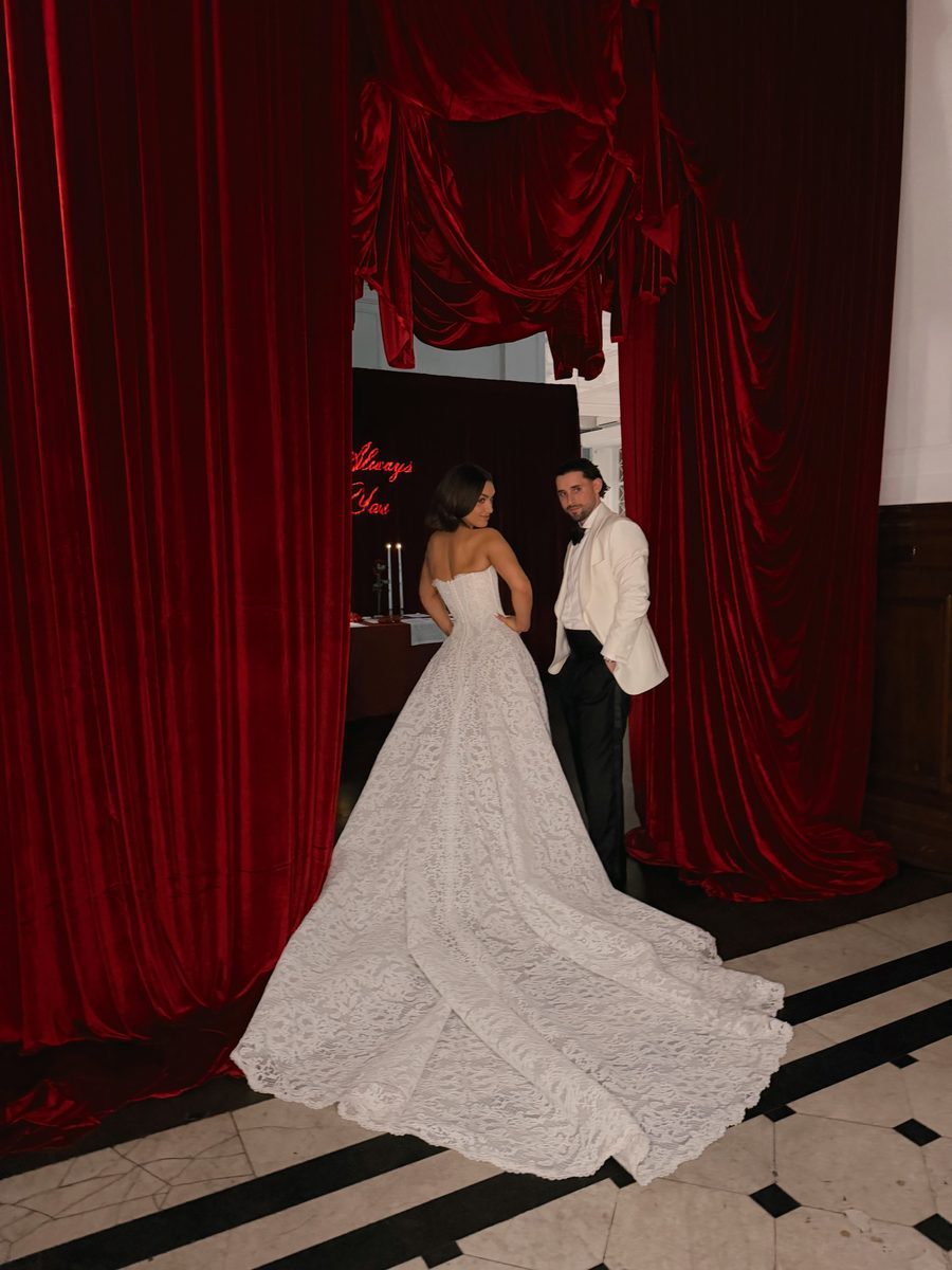 Bride and groom on a red stage