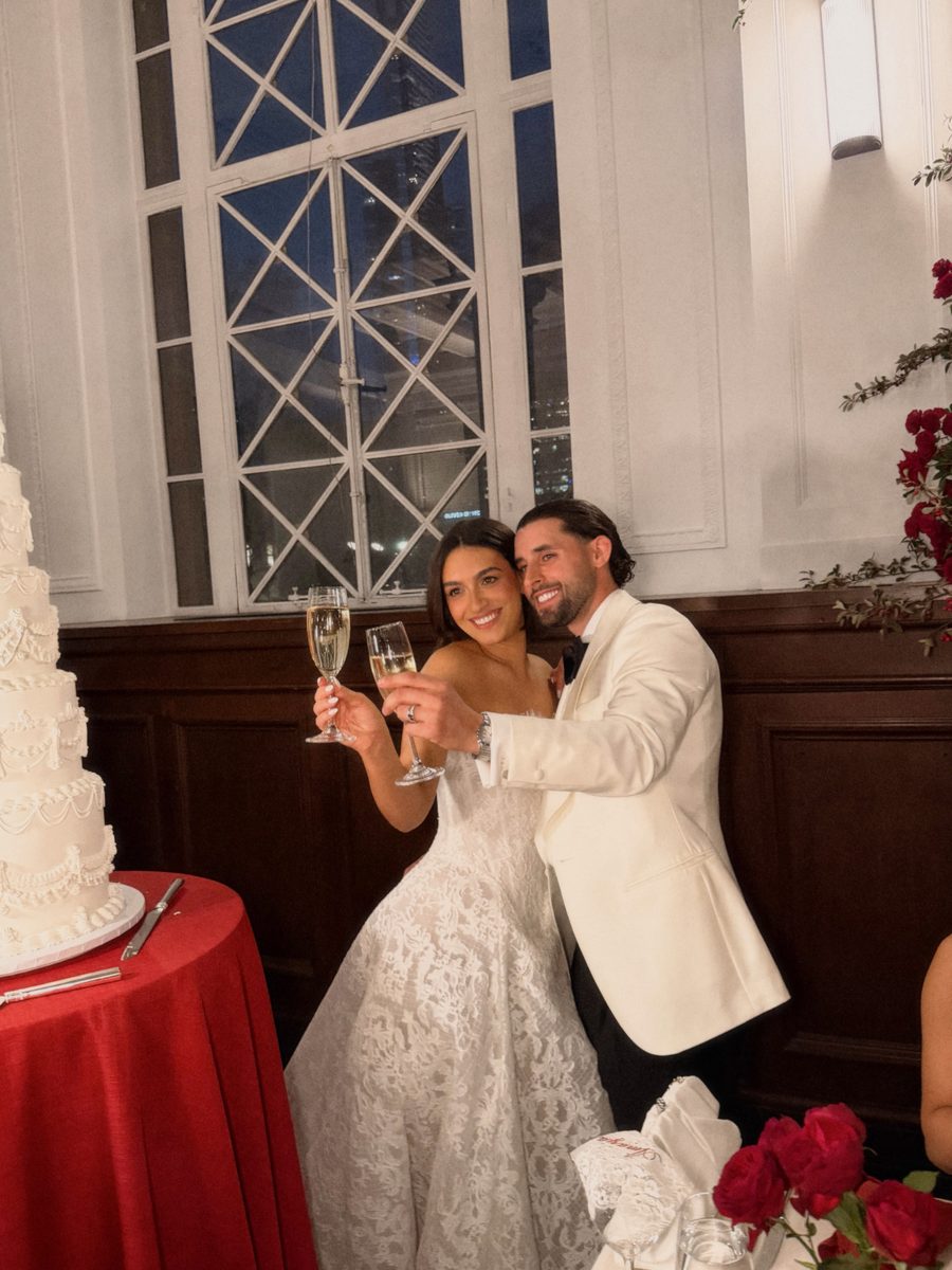 Bride and groom raising a toast at the reception