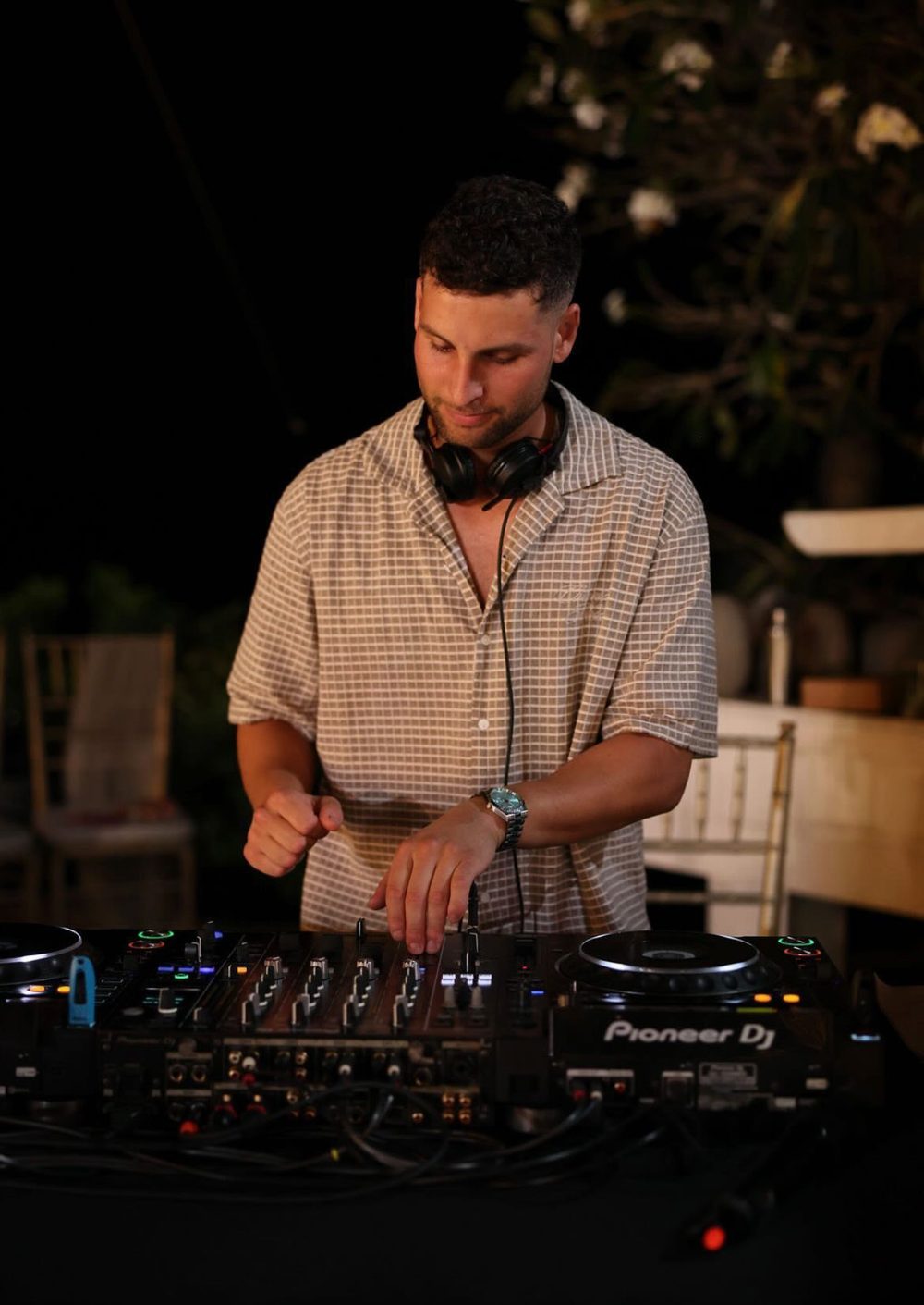 Adrian mixing on a Pioneer club setup at night in Bali
