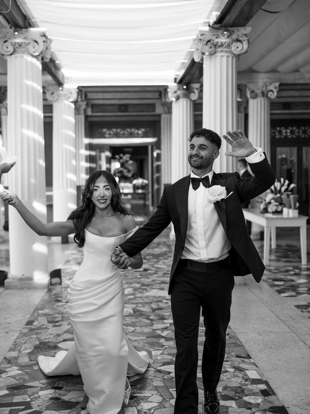 Bride and groom making their entrance through the colonnade