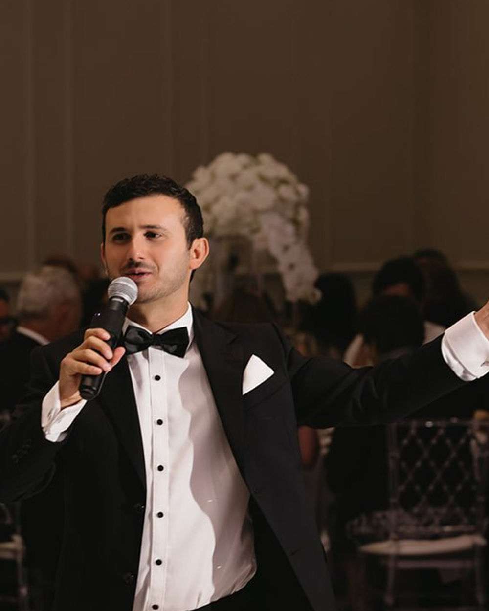 Frank in a tuxedo hosting on the dance floor