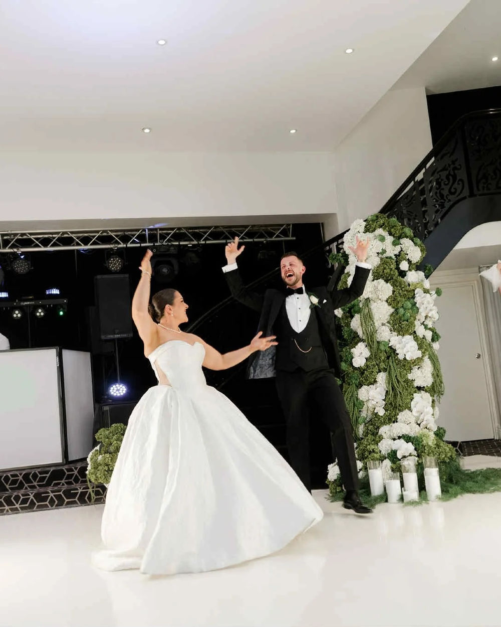 Bride and groom dancing in front of the DJ setup