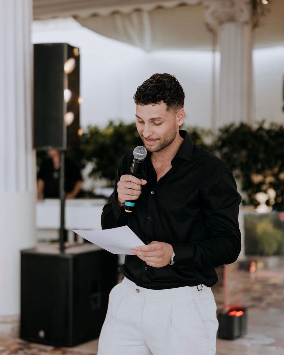 Adrian on the microphone at a wedding in Italy