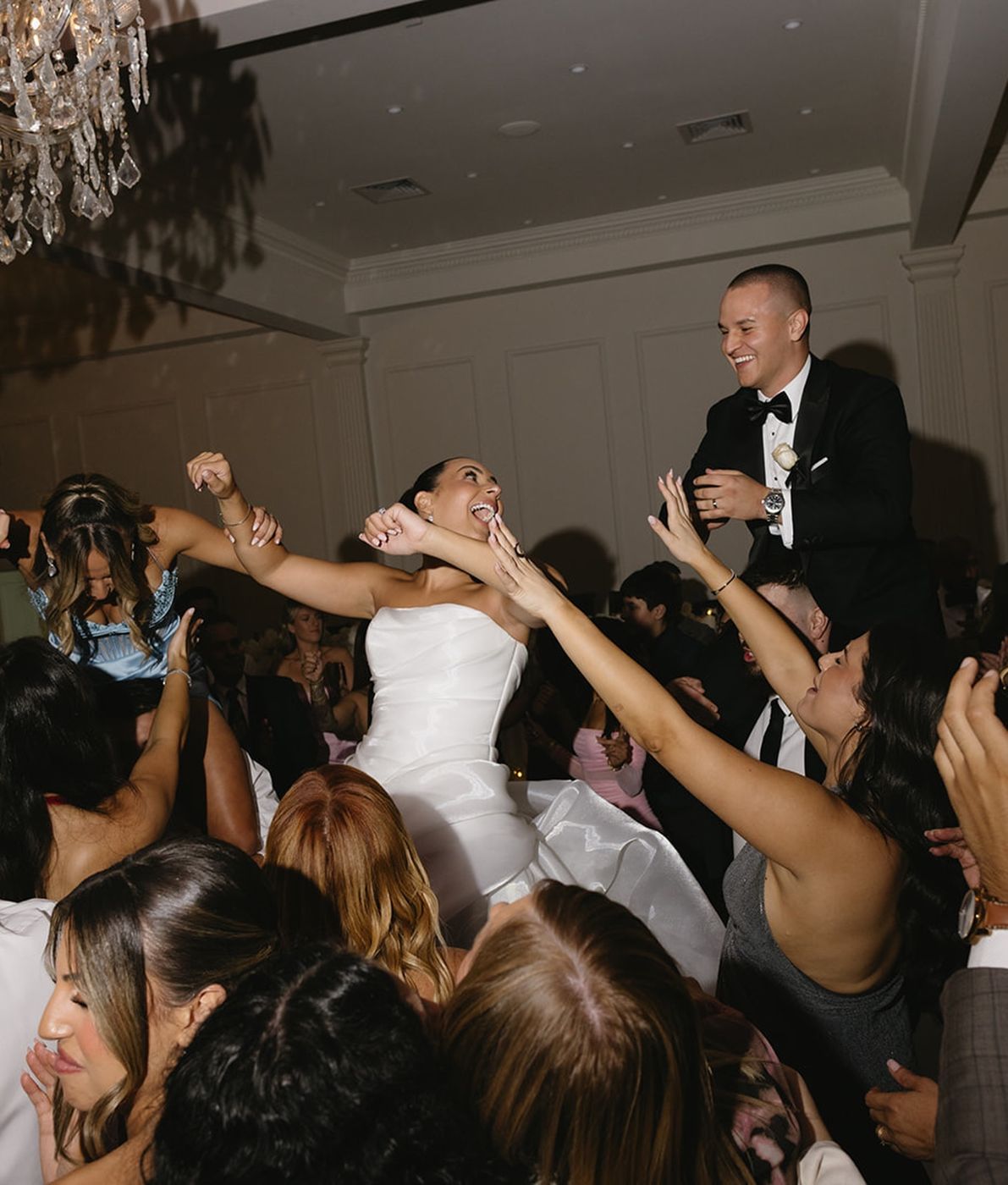 Guests with hands up on the dance floor