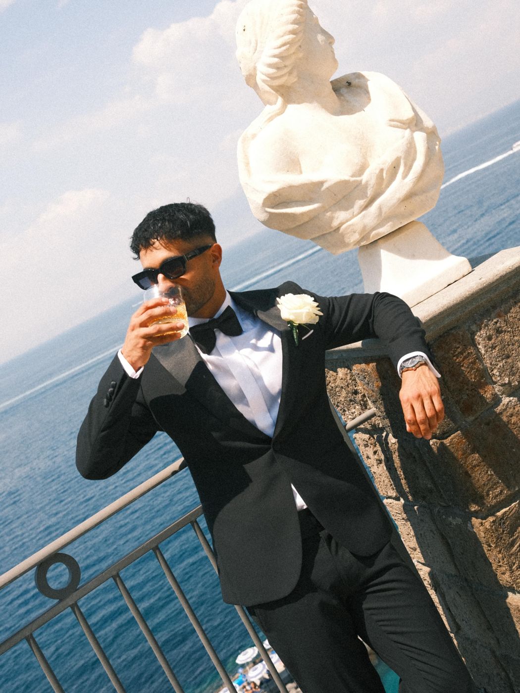 Groom with a drink overlooking the sea in Sorrento